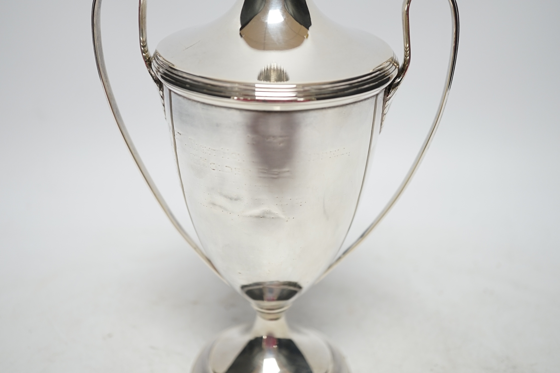 A George V silver two handled urn shaped cup and cover, Goldsmiths & Silversmiths Co Ltd, London, 1922, 23.5cm, 9.8oz. Fair condition.